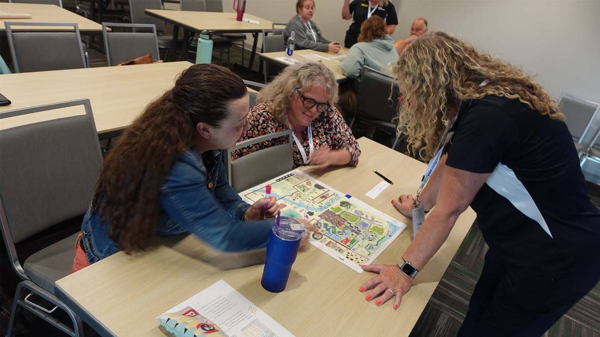 three people working together with map