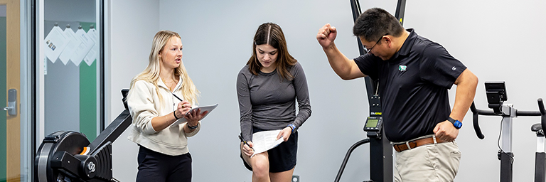 Kinesiology instructor demonstrates exercise for undergraduate students