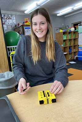 Smiling teacher with instructional tool