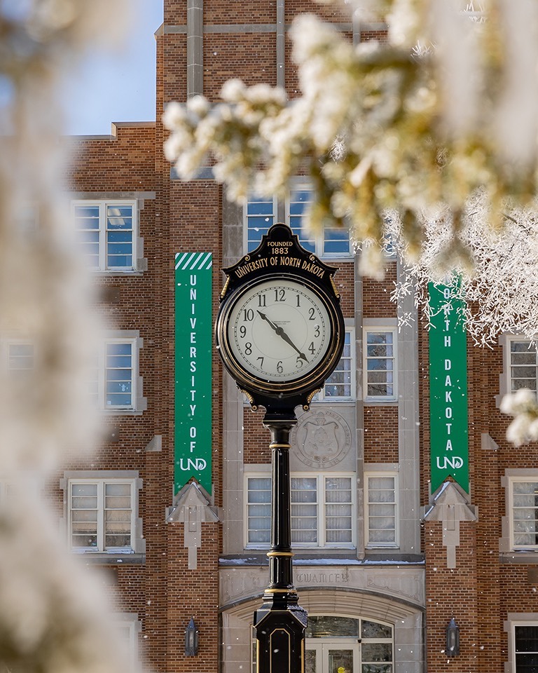 UND historic clock in front of Twamley Hall